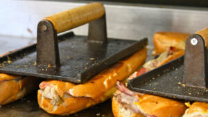 Cubans being pressed on griddle